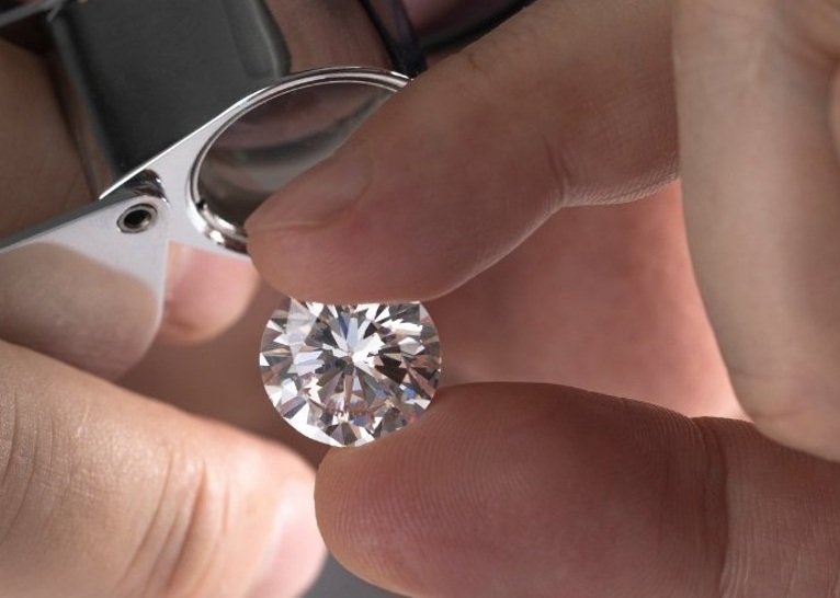 Man in hairnet and mask working on manufacturing equipment