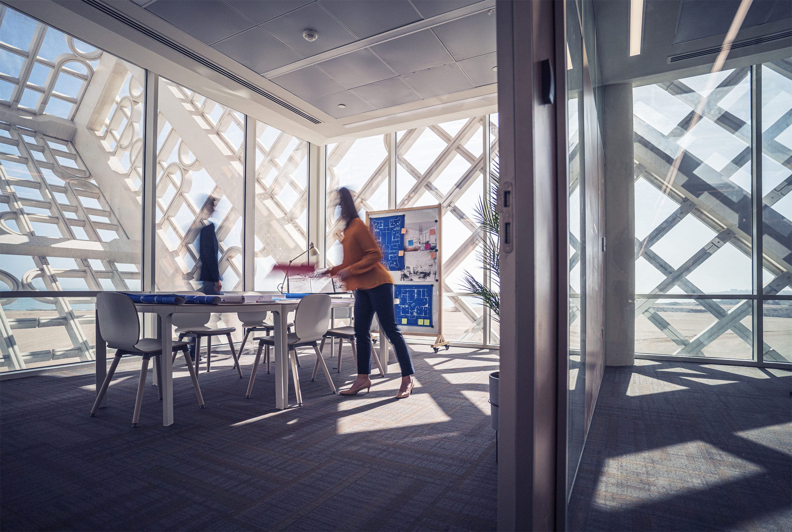 Hamad Port cargo loading, large yellow container cranes placing containers on cargo ships